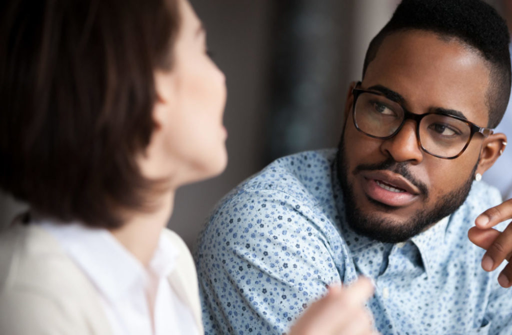 Two people engaged in conversation, listening attentively during a discussion