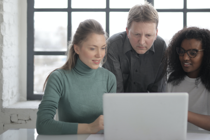 group of people using a laptop