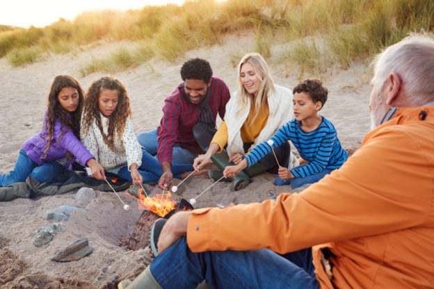 Image: multi generation family around campfire