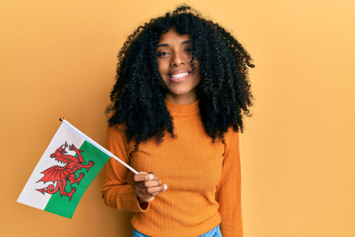 Woman holds a Welsh flag
