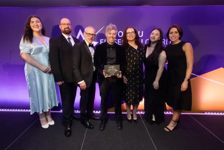 Group of smartly dressed people stand on stage at the Welsh Charity Awards