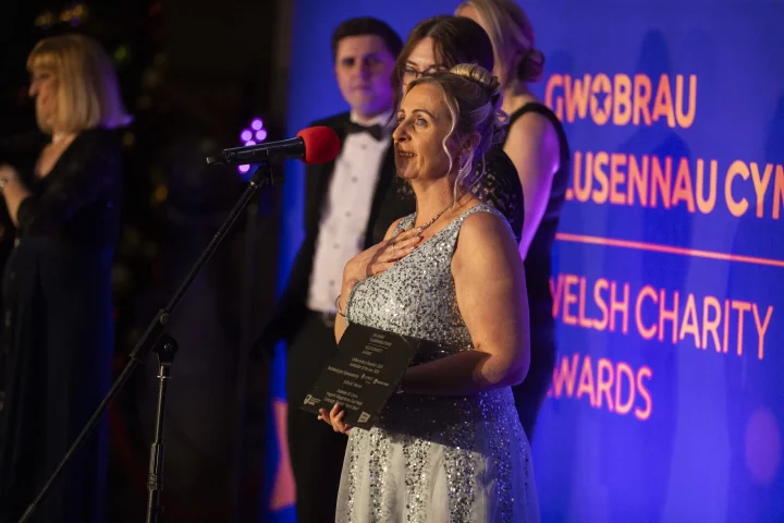One of the winners from the Welsh Charity Awards 2024 receiving an award on stage