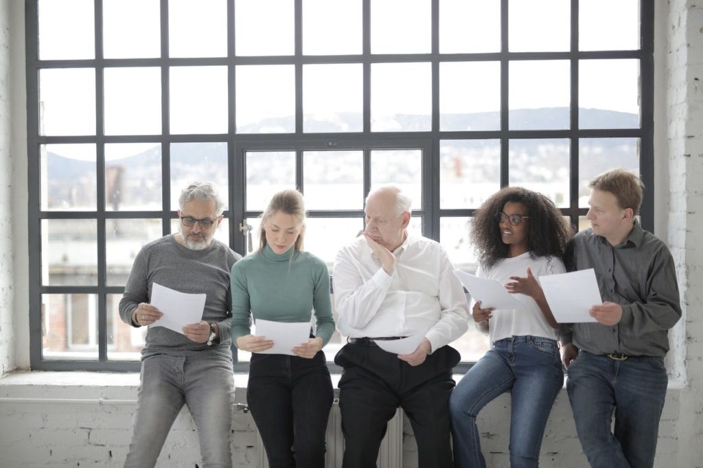Group of people sitting together and reviewing documents