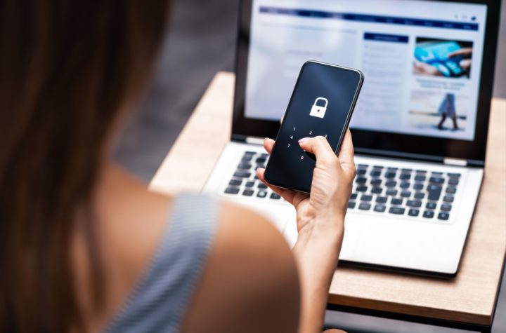 Woman holds a locked smartphone in her hands