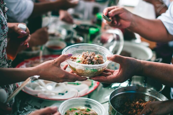 Person hands another person a bowl of food